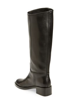 Every wardrobe craves this classic leather riding boot crafted with an asymmetric topline and framed with a rounded toe and chunky block heel. 1 3/4" heel; 1/2" platform 15 3/4" shaft; 15 1/2" calf circumference Pull-on style Leather upper/leather and textile lining/synthetic sole Imported Classic Low Heel Knee-high Boots For Fall, Classic Knee-high Boots With Block Heel, Classic Calf Leather Platform Boots With Square Toe, Classic Square Toe Platform Boots In Calf Leather, Classic Boots With Block Heel And Medium Width, Classic Boots With Block Heel Medium Width, Classic Knee-high Riding Boots For Fall, Classic Wide Calf Boots With Block Heel, Classic Medium Width Boots With Block Heel