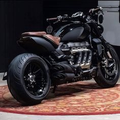 a black motorcycle parked on top of a rug