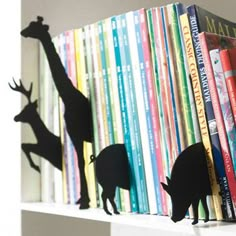 bookshelf with several silhouettes of animals on it