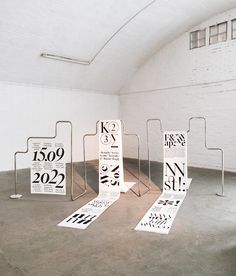 an empty room with several pieces of paper on the floor and signs attached to them