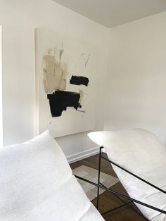 a white couch sitting next to a wall with black paint on it's walls