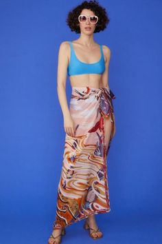 Wrap yourself in luxury with our Multi Tie-Waist Sarong, a versatile piece that exudes tropical elegance. Crafted from a sumptuous blend of cashmere, silk, and cotton, this sarong offers an incredibly soft touch while maintaining a lightweight, airy feel. The vibrant tropical print transports you to paradise, while the contrast hem adds a chic, defined edge. Designed with a flexible tie-waist, this one-size-fits-all sarong is perfect for beach days, poolside lounging, or adding a stylish layer t Silk Sarong For Beach Spring Season, Chic Tie-side Bottom Sarong, Multicolor Silk Sarong For Beach, Summer Silk Printed Bottoms, Silk Sarong For Beach, Elegant Wrap Sarong For Summer, Versatile Summer Wrap Bottoms, Elegant Summer Wrap Sarong, Bohemian Silk Sarong