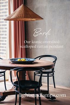 a wooden table sitting under a hanging light