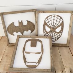 three wooden frames with cutouts of batman, spiderman and iron - man masks