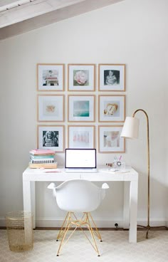 a white desk with pictures on the wall