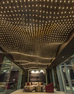 the ceiling is decorated with lights and chairs