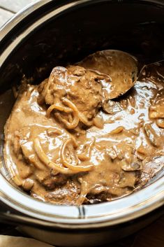 a slow cooker filled with meat and gravy