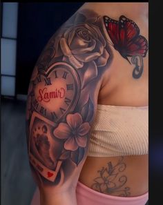 a woman's arm with tattoos on it, and a clock in the middle