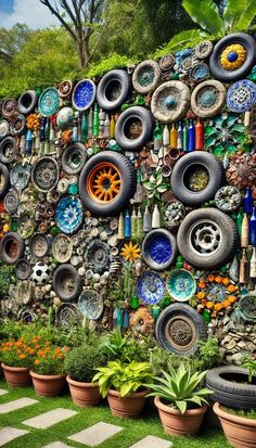 a wall made out of tires and plants