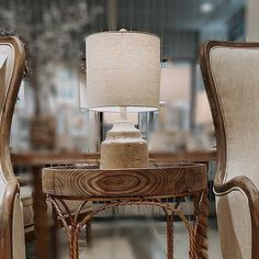 two chairs and a table with a lamp on it