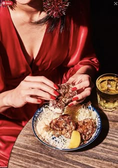 a woman sitting at a table with food in front of her