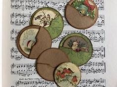 four christmas themed buttons on sheet music