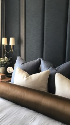 a bed with pillows and lamps on either side of the headboard in a hotel room