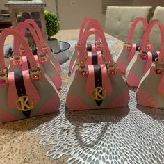 four purses sitting on top of a table in the middle of a living room