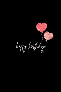 two heart shaped balloons with the words happy birthday written in white on a black background