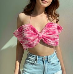 a woman wearing a pink knitted crop top