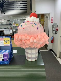 an ice cream cone with sprinkles and a santa hat on top