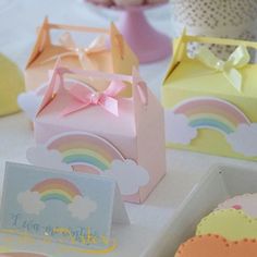 there are many small boxes that have different designs on them, and one has a pink bow at the top