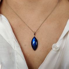 This stunning pendant is set in 14k Solid Yellow Gold with Natural Labradorite having a beautiful blue sheen. It is an unique gemstone pendant for nearly every occasion and is completely hassle-free jewelry. 🔷ABOUT GEMSTONE: Labradorite is a mesmerizing gemstone known for its enchanting play of iridescent colors, often referred to as "labradorescence". With its dark, smoky-gray base and vibrant flashes of blue, green, and gold, it's like holding the Northern Lights in the palm of your hand. Thi Elegant Oval Labradorite Pendant Jewelry, Blue Marquise Necklace For Gift, Blue Marquise Necklace For A Gift, Handmade Jewelry Box, Birthstone Pendant, Labradorite Pendant, Unique Gemstones, 14kt Gold, Free Jewelry