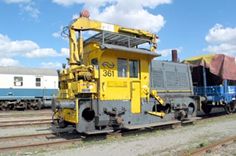 a yellow train engine sitting on the tracks