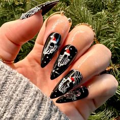 Dawn Witch Designs Unique, re-usable, hand painted, and made in Canada. These luxury press on nails are handmade using high quality gel polish and salon-grade materials.  ✨ GHOSTS OF CHRISTMAS PAST, PRESENT FUTURE✨  Celebrate the famous Christmas Carol story with this manicure that features festive ghosts of past, present, and future. These adorable ghosts wear hand-painted Santa hats. *The shape shown in the pictures is the MEDIUM STILETTO *Colours may appear a little different due to your personal monitor settings* ✨ BUY 3 GET 1 PROMOTION ✨  ➜ Buy 3 sets of press on nails and get a free solid set!  ➜ How: Purchase 3 sets of nails, and then message me with the following information for your free solid set:  1: colour (choose any solid colour from the "Solid Nails" section)  2: the length/ Holiday Goth Nails, Christmas Nails Short Stiletto, Christmas Story Nails, Christmas Stilleto Nails Designs, Black And Silver Stiletto Nails, Medium Length Nails Designs, Scary Christmas Nails, Jack Skellington Christmas Nails, Alt Christmas Nails