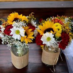 three mason jars filled with sunflowers and baby's breath