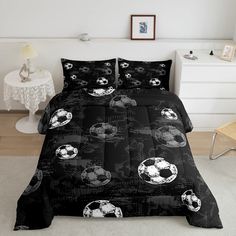 a black and white bed with soccer balls on it