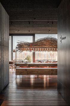 an open room with wooden flooring and large windows looking out onto the outside area