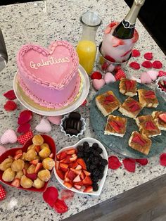 valentine's day desserts are arranged on a table