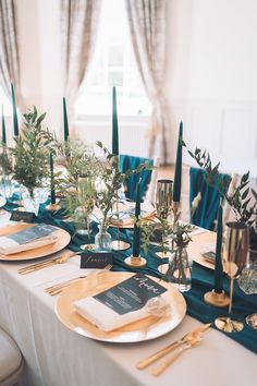 the table is set with candles and place settings