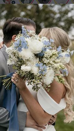 a bride and groom kissing in front of the camera