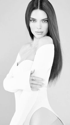 a woman with long hair posing for the camera