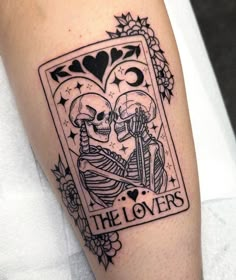 a couple of skeletons holding each other in the shape of a playing card with the words the lovers on it