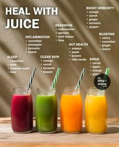 three jars filled with different types of juices on top of a wooden table next to a wall