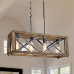 a wooden light fixture hanging from a ceiling