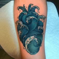 a tattoo with an ocean wave on it