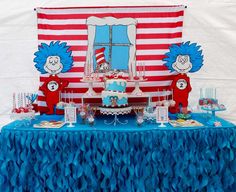 a dr seuss themed birthday party with blue and red decorations on a table cloth