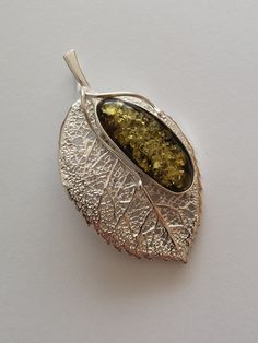 Brooch - PENDANT, silver leaf, pr. 925, mesh of natural green amber with dimensions of 13/32 mm, dimension of brooch - pendant 35/60 mm, weight 11.7 g. The product is made using a unique technique, hand-made, design, modern, individual and combining two pendant functions and brooches, created for women who like interesting and unique design. Give yourself a little pleasure. We invite you to familiarize yourself a little pleasure. We invite you to familiarize yourself with the products at www.was Elegant Leaf-shaped Brooches For Gifts, Amber Brooch Jewelry Gift, Pendant Silver, Silver Leaf, Design Modern, Pendant Necklaces, Poland, Jewelry Necklace Pendant, Etsy Accessories