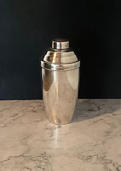 a metal container sitting on top of a marble counter