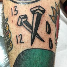 a close up of a person's leg with tattoos on their legs and numbers