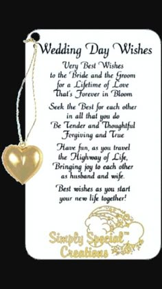 a wedding day wishes card with a gold heart hanging from the front and back of it