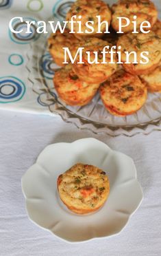 some muffins are sitting on a plate with the words crawfish pie muffins