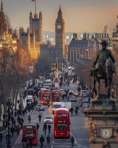 a busy city street with double decker buses and big ben in the background