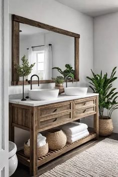 a bathroom with two sinks and a large mirror above the sink in front of a potted plant