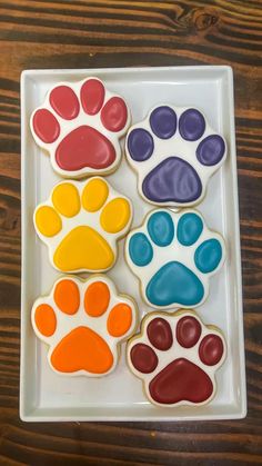 the cookies are decorated with different colored paw prints