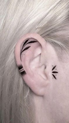 a woman's ear with black arrows on it