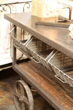 an old metal table with two baskets on it's top and one drawer open