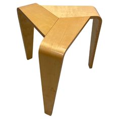 a wooden stool with curved legs on a white background