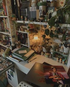 a cluttered room with many books and plants