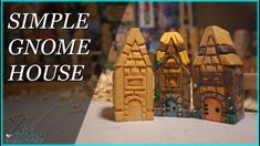 three small wooden houses sitting next to each other on a table with the words, simple gnome house